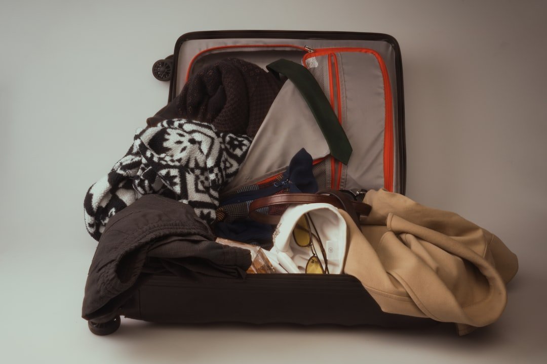 Partly packed suitcase with intentional space left for the return trip